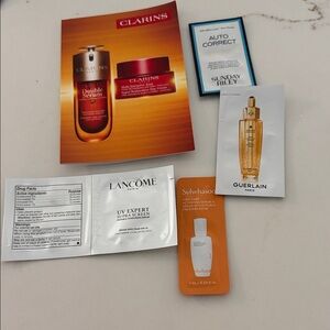 Clarins Sample Card with Orange, White, Gold Accents